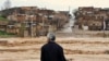 IRAN -- A man watches as floodwaters hit the city of Khorramabad in the western province of Lorestan, April 1, 2019