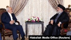 Lebanon's Hizballah leader Sayyed Hassan Nasrallah meets with Iranian Foreign Minister Mohammad Javad Zarif in this handout picture released by Hezballah Media Office, February 11, 2019. File photo