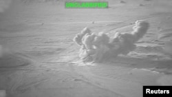 Smoke rises from an explosion at an unknown location, during what US Central Command (CENTCOM) says are strikes on Iran, in this still image taken from a handout video released on July 19.