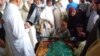 Family and friends grieve over the body of Bakht Bibi, who along with her daughter and niece were among the more than 20 people killed in the twin attacks in the Pakistani city of Quetta on September 7.