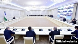 Uzbek President Shavkat Mirziyov (left) holds an emergency meeting on the coronavirus.