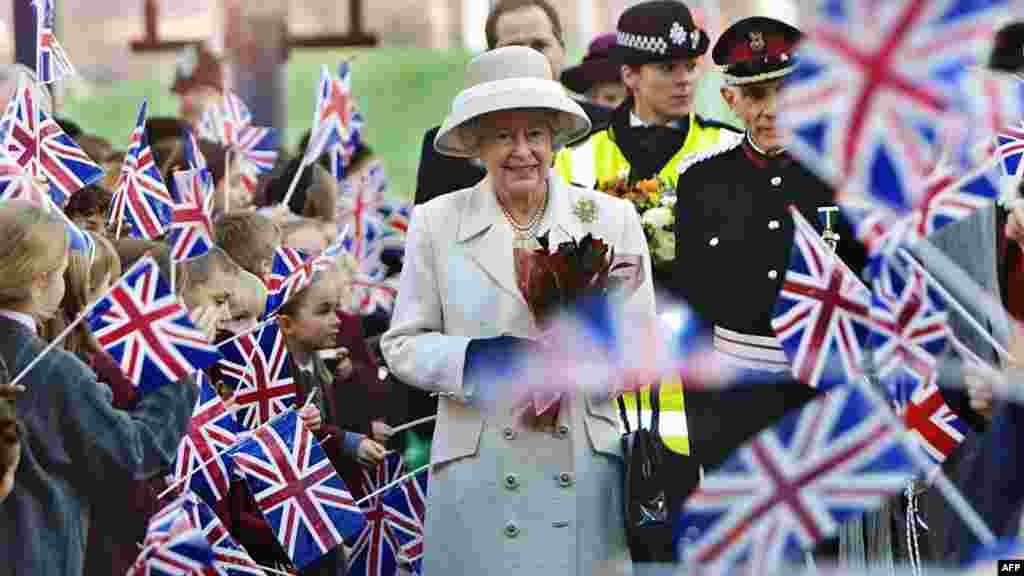 Queen Elizabeth II is greeted by well-wishers on a visit to the newly reconstructed Queen Elizabeth Hospital in London in 2001.