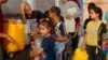 EDITORS NOTE: Graphic content / Palestinians line up to refil their water containers in Rafah on the southern Gaza Strip on October 24, 2023, amid the ongoing battles between Israel and the Palestinian group Hamas. (Photo by MOHAMMED ABED / AFP)