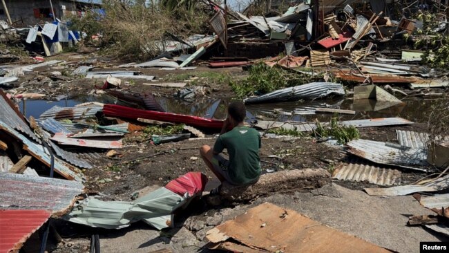 Një djalë qëndron pranë rrënojave të shtëpive, pas ciklonit Chido, në Labattoir, në Majot, më 15 dhjetor 2024.