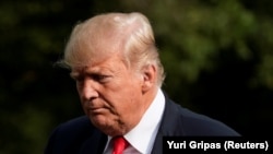 U.S. -- U.S. President Donald Trump walks on the South Lawn of the White House upon his return from Bedminster, New Jersey, to Washington, U.S., August 19, 2018