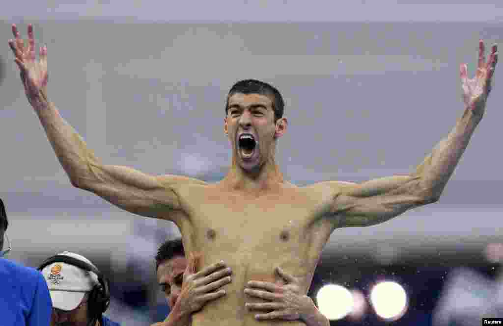 Michael Phelps and Garrett Weber-Gale celebrate after the U.S. won the men's 4x100m freestyle relay swimming final at the National Aquatics Center during the Beijing 2008 Olympic Games August 11, 2008. REUTERS/David Gray 