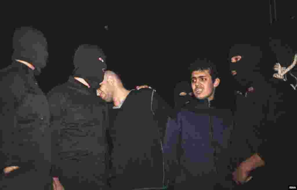 Alireza Mafiha rests his head on the shoulder of an executioner, who has his arm around him, moments before his death by hanging in Tehran. Mafiha was publicly executed along with Mohammad Ali Sarvari (second from right) after a video was posted on YouTube in December showing them robbing and stabbing a man on a street in Tehran. The man survived. Judiciary chief Ayatollah Sadeq Larijani called it a &quot;moharebeh&quot; crime, which Iran&#39;s legal code defines as &quot;defiance of God,&quot; or the state, and is punishable by hanging. (ISNA)