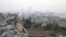 Syrian regime forces gather at the Kindi Hospital as smoke billows following air strikes on Aleppo on October 2.