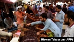 Residents buy dates at a market ahead of Ramadan during a government-imposed nationwide lockdown to stem the spread of the coronavirus, in Karachi on April 20.