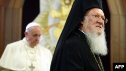 Pope Francis (left) and Ecumenical Patriarch Bartholomew I leave after they signed a joint statement at St. George church in Istanbul on November 30.