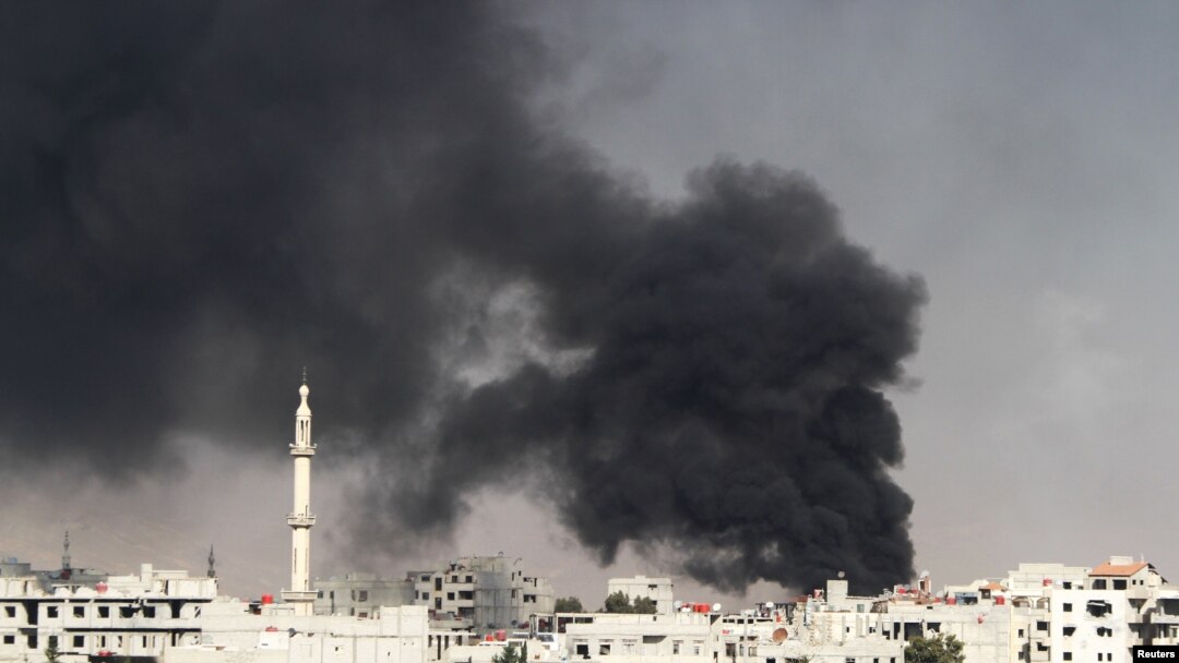 Smoke rises from the eastern Damascus suburbs of Arbeen after what activists say was an air strike by a fighter jet on November 8.