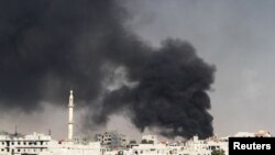 Smoke rises from the eastern Damascus suburbs of Arbeen after what activists say was an air strike by a fighter jet on November 8.