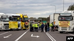 Transport company owners stand together as they block access to the Polish-Ukrainian border crossing in Dorohusk, Poland, on November 6 to protest against what they call unfair competition.