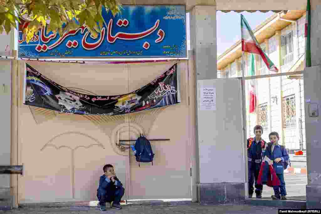 Children wait for their parents after classes at the Parvin Etesami secondary school.