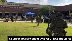 Law enforcement officers respond at Santa Fe High School following the shooting incident in Texas on May 18.