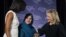 First Lady Michelle Obama (left) and U.S. Secretary of State Hillary Clinton (right) congratulate Shad Begum of Pakistan during the U.S. State Department's 2012 International Women of Courage Award winners' ceremony on March 8.