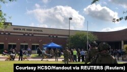 Law enforcement officers respond to the shooting at Santa Fe High School in Texas on May 18.