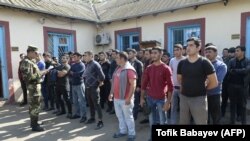 AZERBAIJAN -- Men gather at a military commissariat in a settlement in Azerbaijan's Beylagan district, September 30, 2020