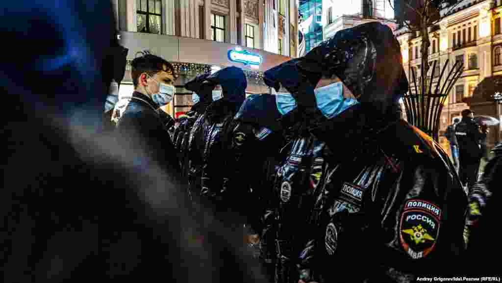 An opposition supporter asks police to let him pass through the cordon in the center of Kazan.