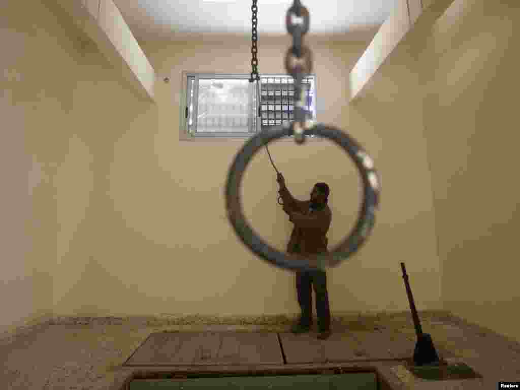 A man checks the execution room inside the burned-out main prison of Qaddafi's forces in Benghazi on February 28. Photo by Suhaib Salem for Reuters