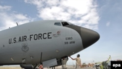 US soldiers inspect military planes at the Manas air base