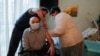 An elderly Ukrainian man receives a dose of a Chinese-developed vaccine against COVID-19 at his home in Kyiv earlier this year. 