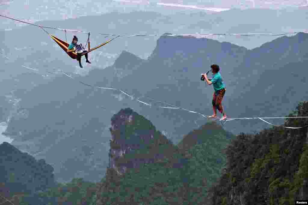 Members of the performing group Houle Douce practice their instruments on tightropes ahead of a show at the Tianmen Mountain National Park in Hunan Province, China. (Reuters)