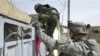 Iraqi and U.S. soldiers search a house in Diyala governorate