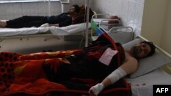 Afghan men are treated in a hospital after being injured in a car-bomb attack in Kabul on July 24.