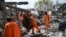 Afghan municipality workers clear debris from the site after Pakistani airstrikes hit the Omid Addiction Treatment Hospital in Kabul, on March 17, 2026.