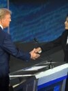 TOPSHOT - US Vice President and Democratic presidential candidate Kamala Harris (R) shakes hands with former US President and Republican presidential candidate Donald Trump during a presidential debate at the National Constitution Center in Philadelphia, 