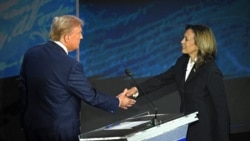 TOPSHOT - US Vice President and Democratic presidential candidate Kamala Harris (R) shakes hands with former US President and Republican presidential candidate Donald Trump during a presidential debate at the National Constitution Center in Philadelphia, 