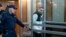 Gordon Black is escorted into a Russian courtroom on June 6.