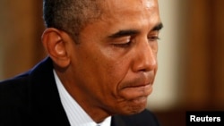 U.S. President Barack Obama pauses while speaking to reporters about Syria during a meeting with Baltic leaders in the Cabinet Room of the White House in Washington August 30.