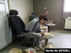 Dana and Vaso Sunjevaric prepare their wheels for the next lump of clay.