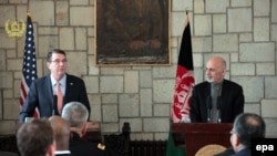 U.S. Secretary of Defense Ashton Carter (L) and Afghanistan's president, Ashraf Ghani, talk with journalists during a joint press conference in Kabul on February 21.