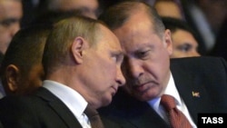 Russian President Vladimir Putin (left) and Turkish President Recep Tayyip Erdogan talk during the 23rd World Energy Congress in Istanbul on October 10.