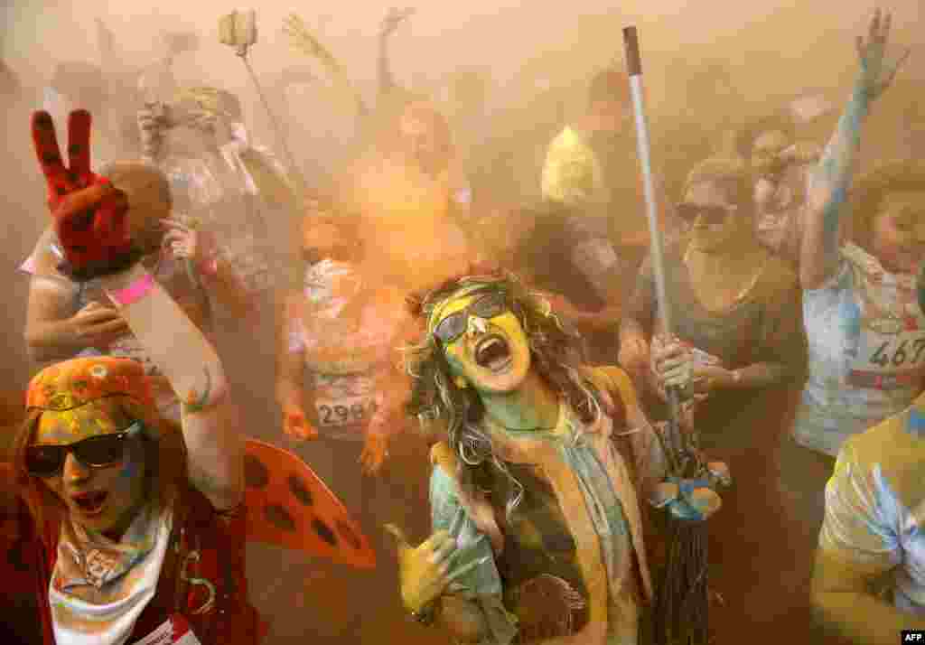 Runners covered in colored powder celebrate after taking part in the 2017 Color Run at the Luzhniki Olympic Complex in Moscow. (AFP/Maxim Zmeyev)