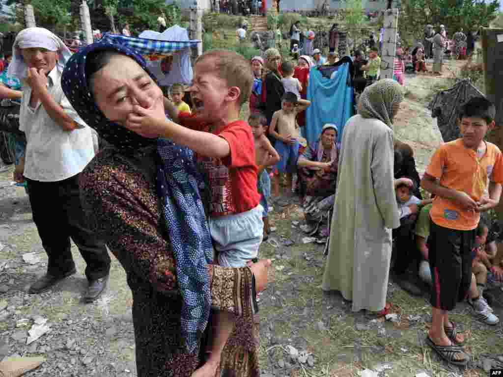 Ethnic Uzbek refugees stand on the Kyrgyz-Uzbek border outside the village of Suratash on June 14.