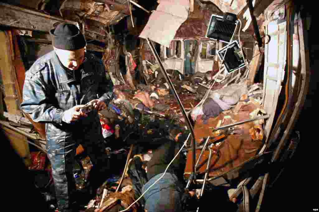 A police officer inspects the destroyed metro car. The explosion was identified as an attack by a suicide bomber. 