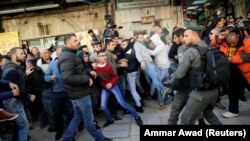 Israeli police and Palestinians scuffle after Friday Prayers in Jerusalem's Old City on December 8.