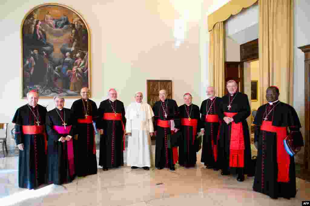 Vatican -- Pope Francis (C) poses with Cardinals before their meeting at the Vatican, October 1, 2013
