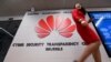 File photo: Belgium - A woman walks past a logo at the entrance of the European Huawei Cyber Security Transparency Centre during its opening in Brussels on March 5, 2019.