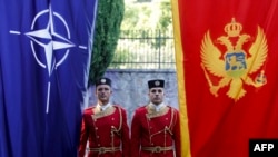 Montenegro -- Montenegrin honor guards stand next to NATO and Montenegrin flags during a ceremony in the capital Podgorica, June 7, 2017