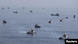 Iranian ships participate in a naval parade during military exercises near the Strait of Hormuz earlier this month.