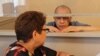 Toktar Toleshov (right) in a courtroom with his lawyer Markhaba Zhakypova on July 13. 
