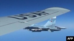 A Russian SU-27 Flanker fighter plane photographed from a U.S. Air Force reconnaissance jet over the Baltic Sea