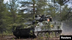 A British Warrior infantry fighting vehicle takes part in the Northern Forest exercises in Rovajarvi, Finland, on May 30.