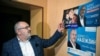 Boris Nadezhdin, the Civic Initiative Party presidential hopeful, talks to an AFP reporter by his campaign posters from past regional elections at his flat in Dolgoprudnyy on January 24, 2024.