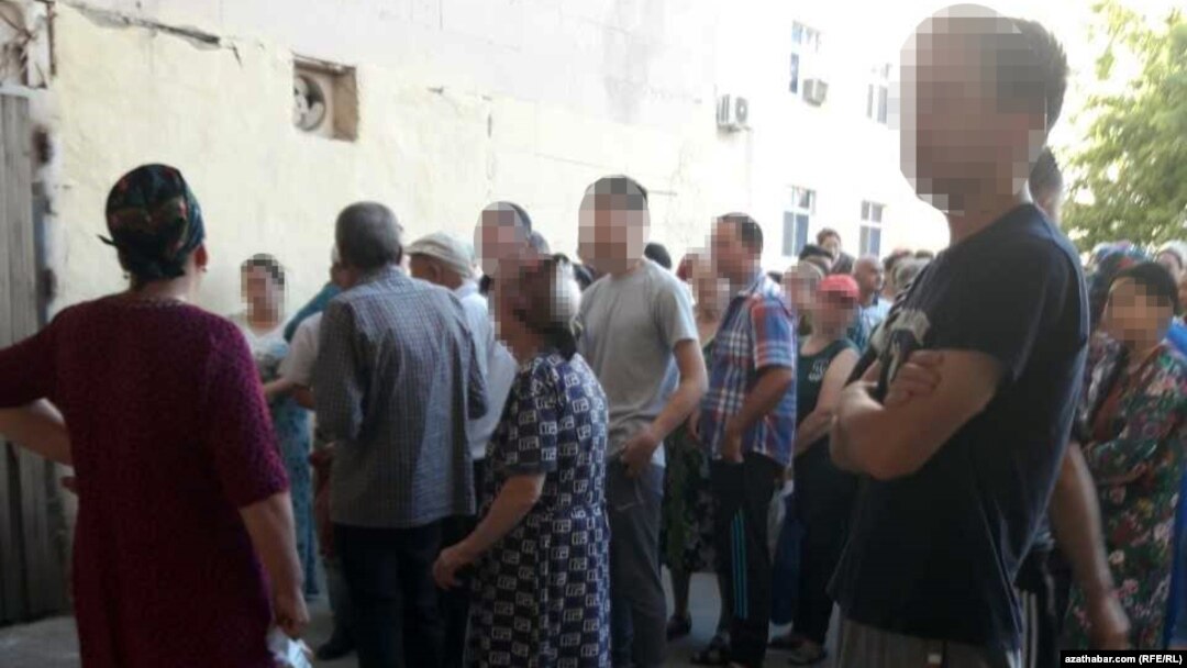 People wait for a chance to buy subsidized food at a state store in Ashgabat in 2019.